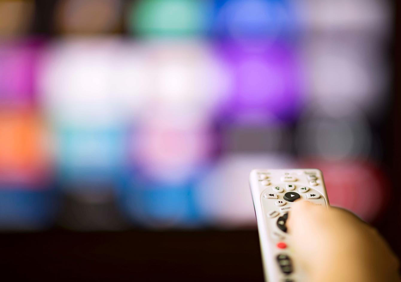 A remote control pointing towards a television