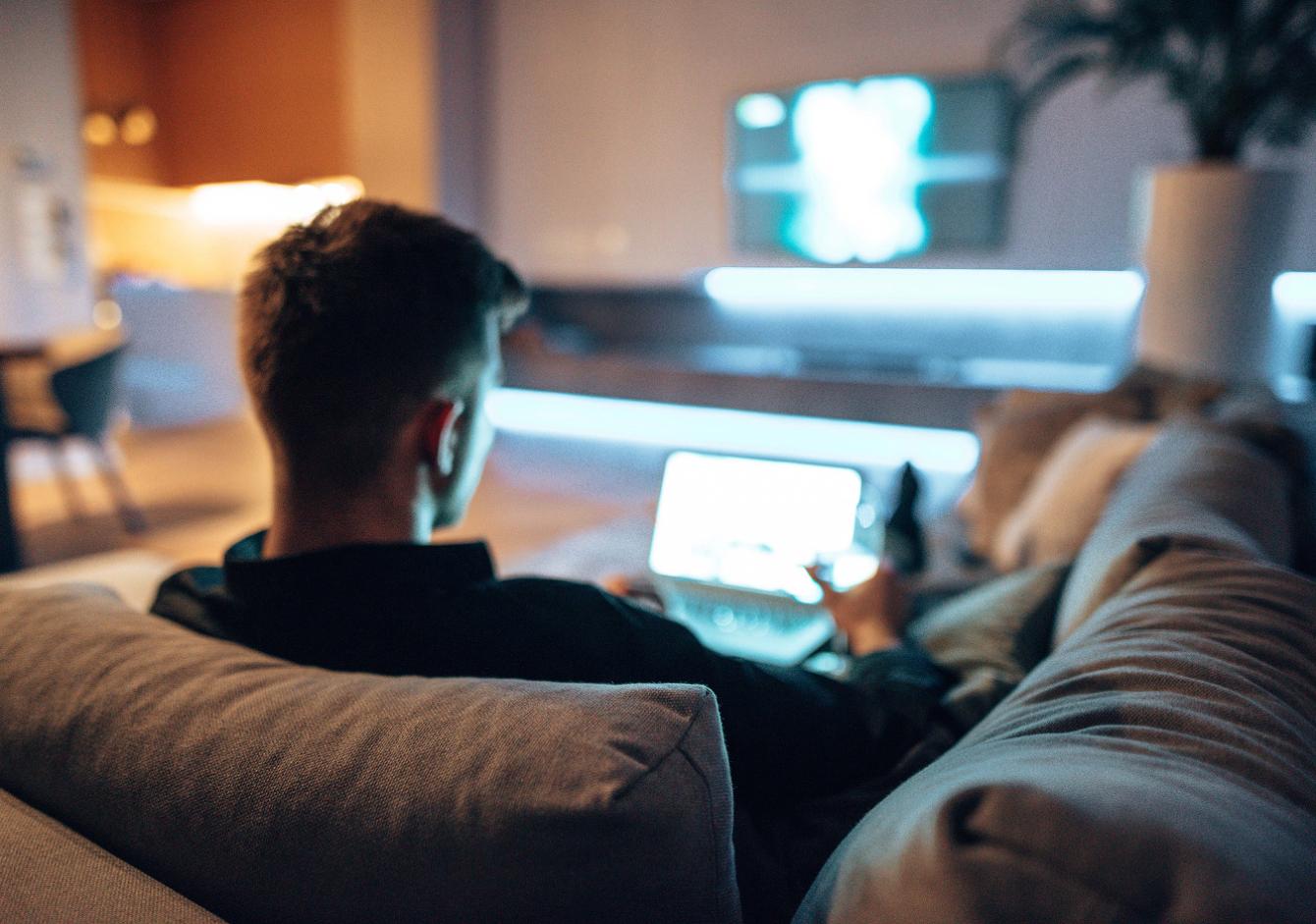 A young man viewing a laptop